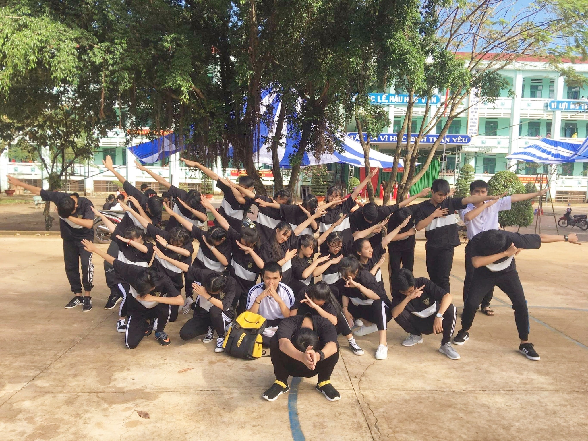 Classmates posing together in an airline-style formation.