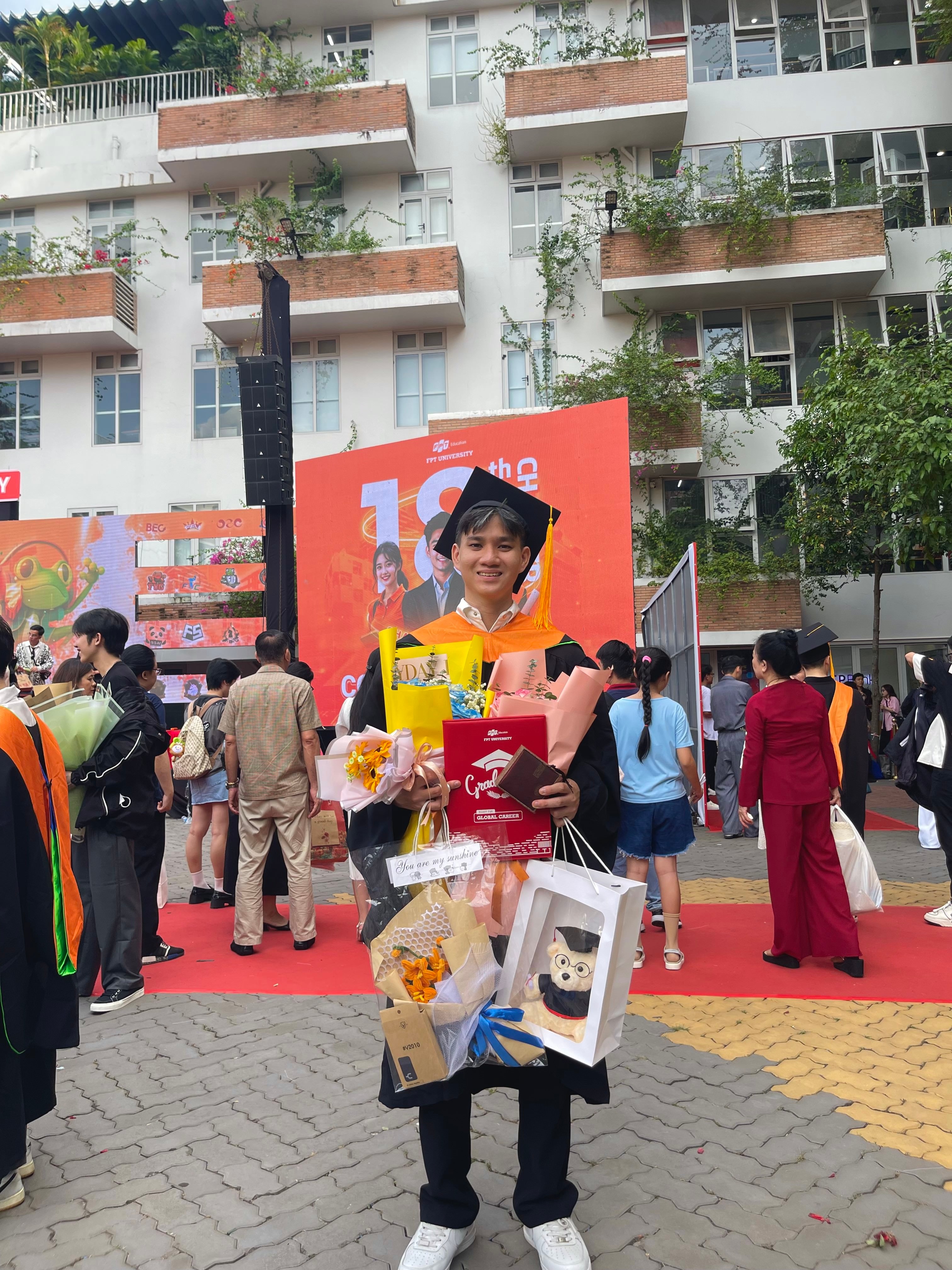 A person in graduation attire at a ceremony.