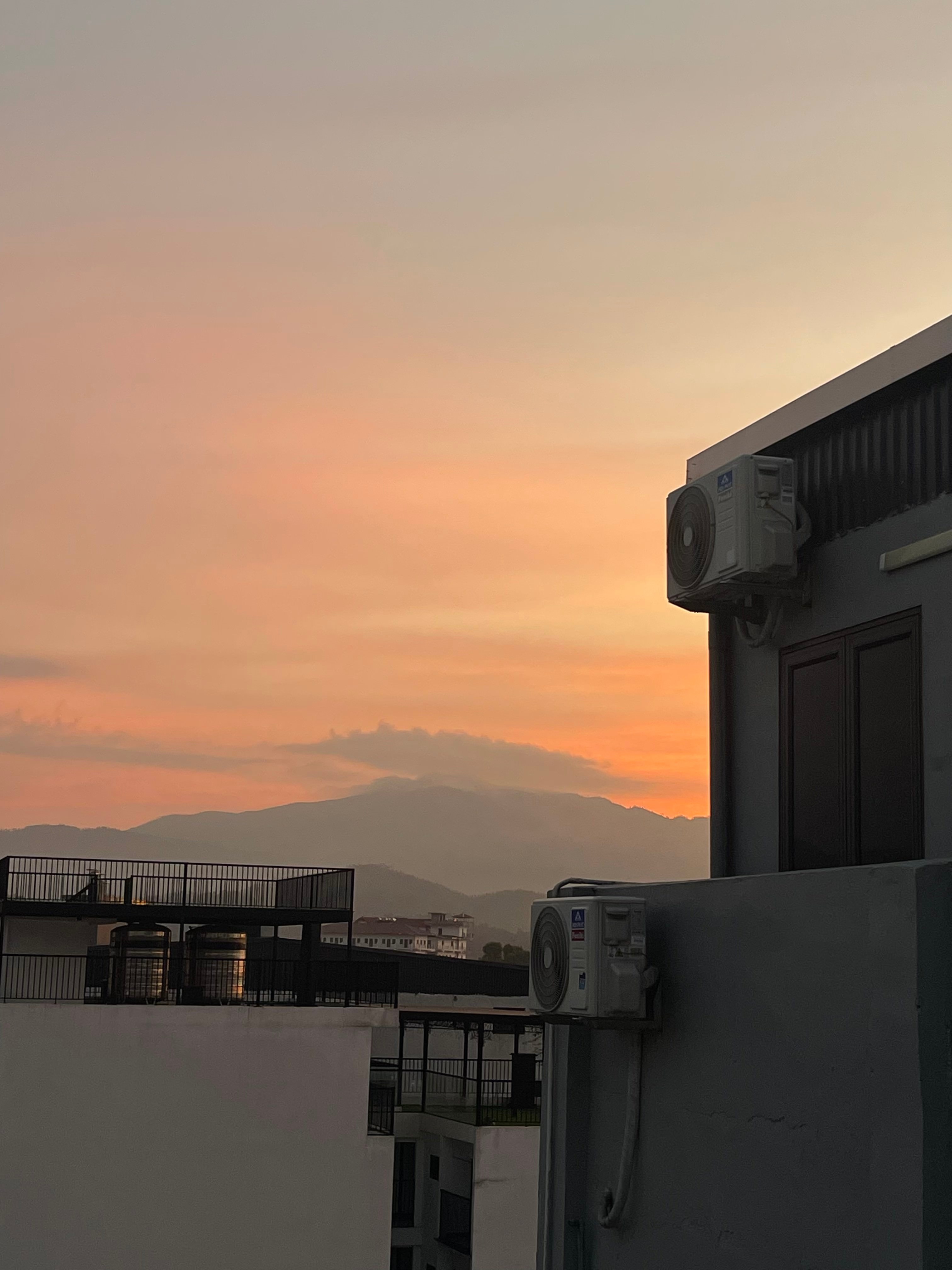 A second sunset view from a Hanoi room window.