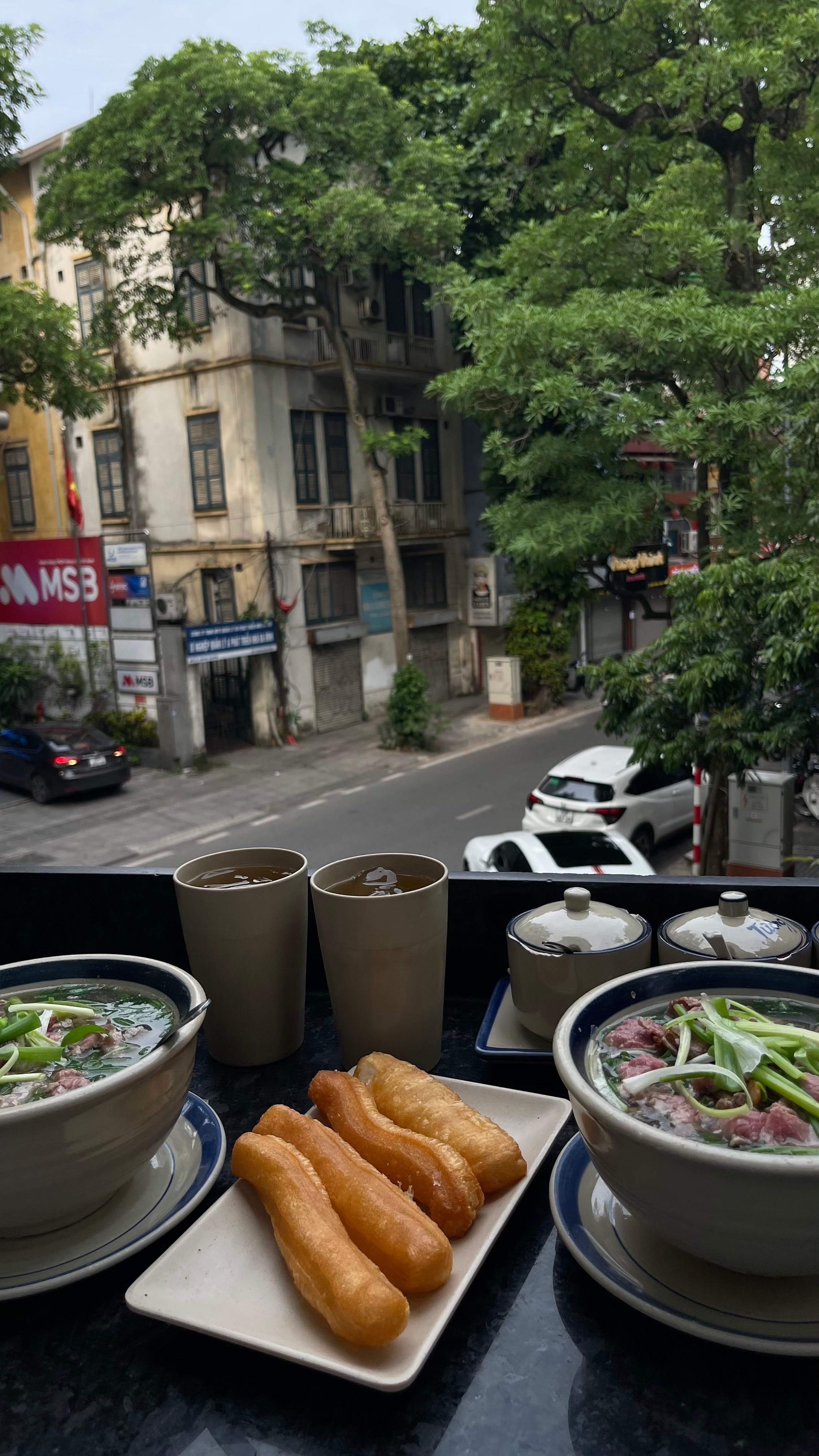 A bowl of phở on a table.